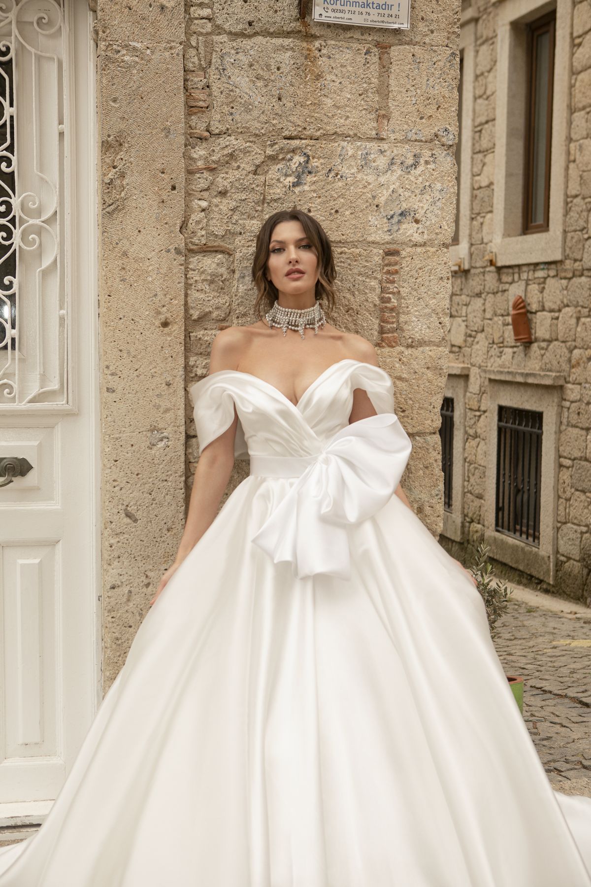 Satin white wedding gown Stella with a bow, off-shoulder sleeves and a-line skirt by Oksana Mukha designer 3