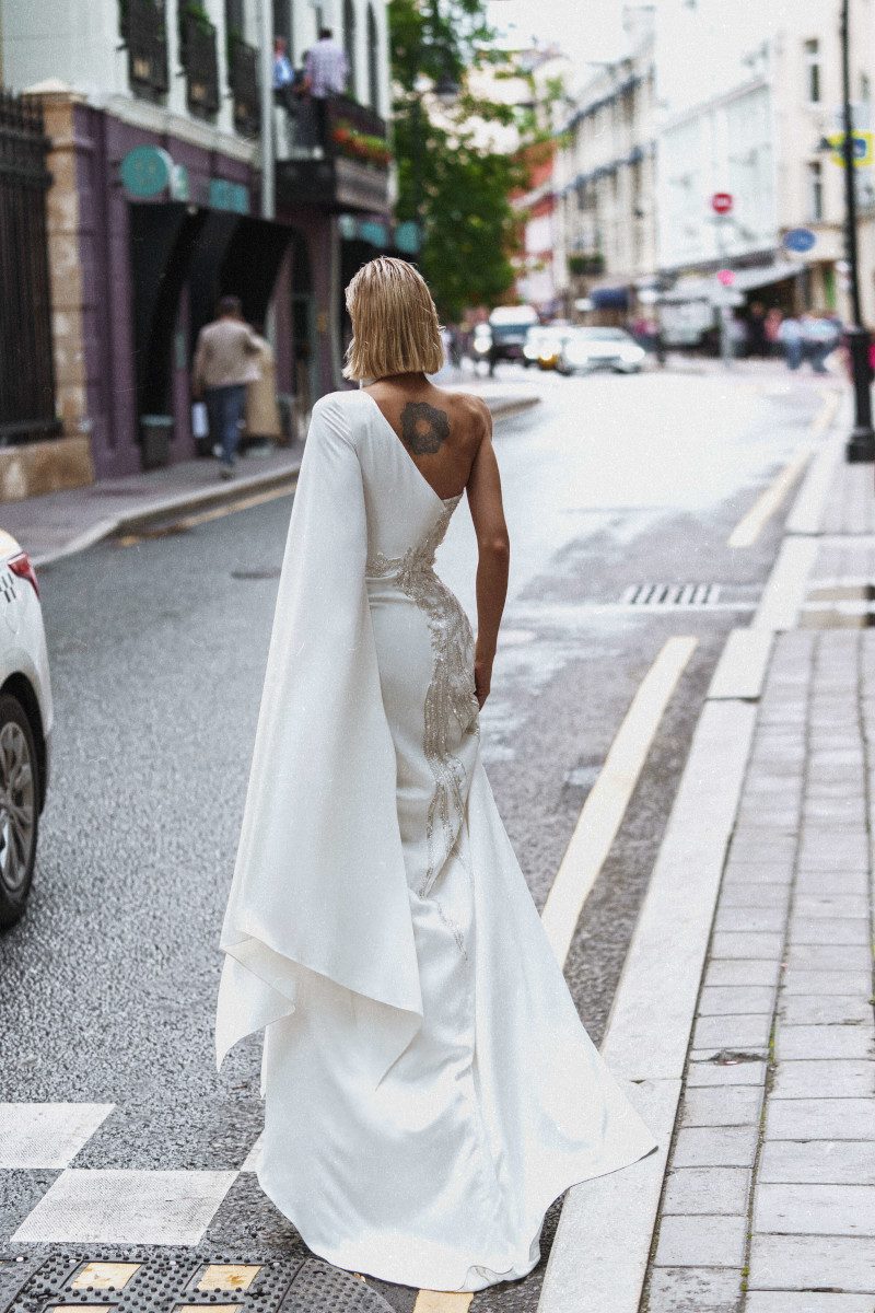 Fitted wedding gown Kasama with one shoulder and the skirt split by Rara Avis at Dell'Amore Bridal, Auckland. 3