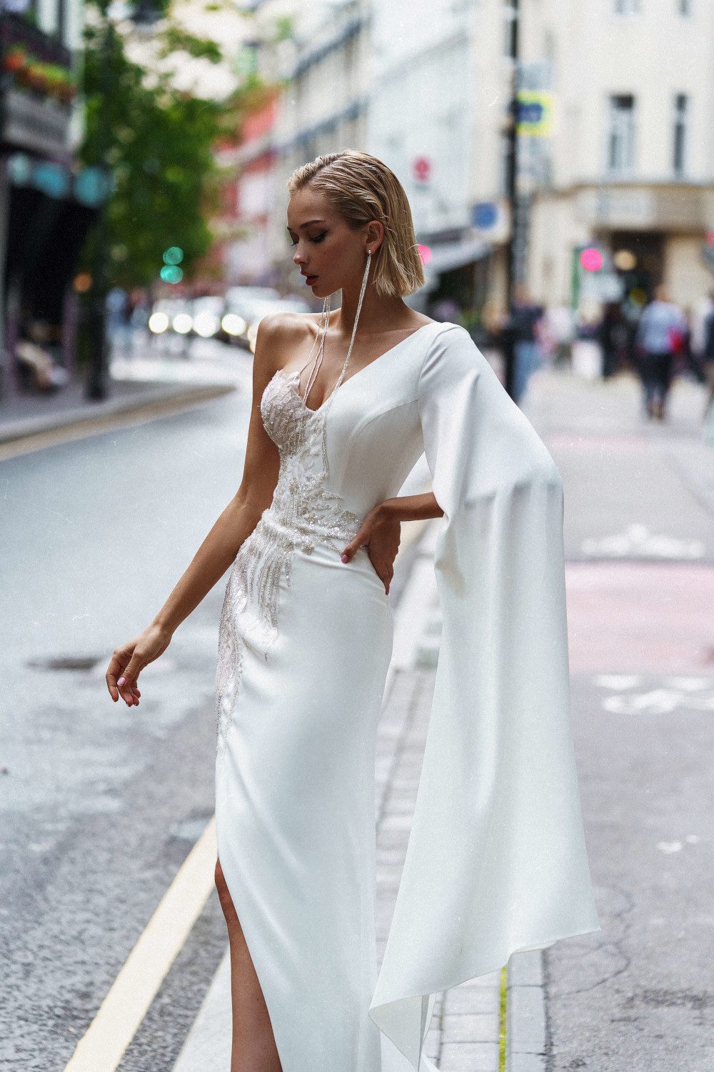 Fitted wedding gown Kasama with one shoulder and the skirt split by Rara Avis at Dell'Amore Bridal, Auckland. 1