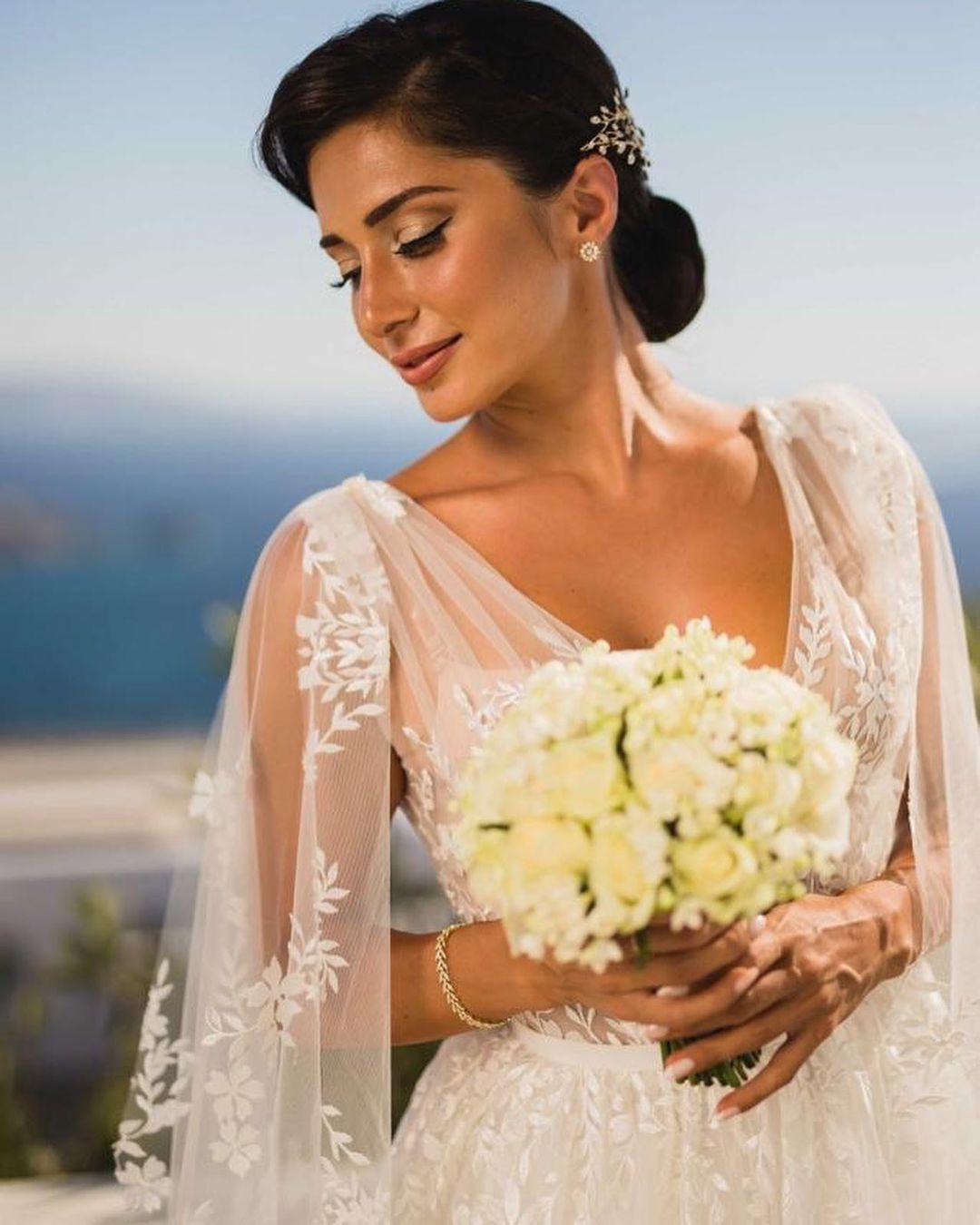 A bride wearing lace princess wedding dress Nilsa by Blammo-Biamo with long flared lace sleeves at Dell'Amore Bridal, Auckland, NZ. 1