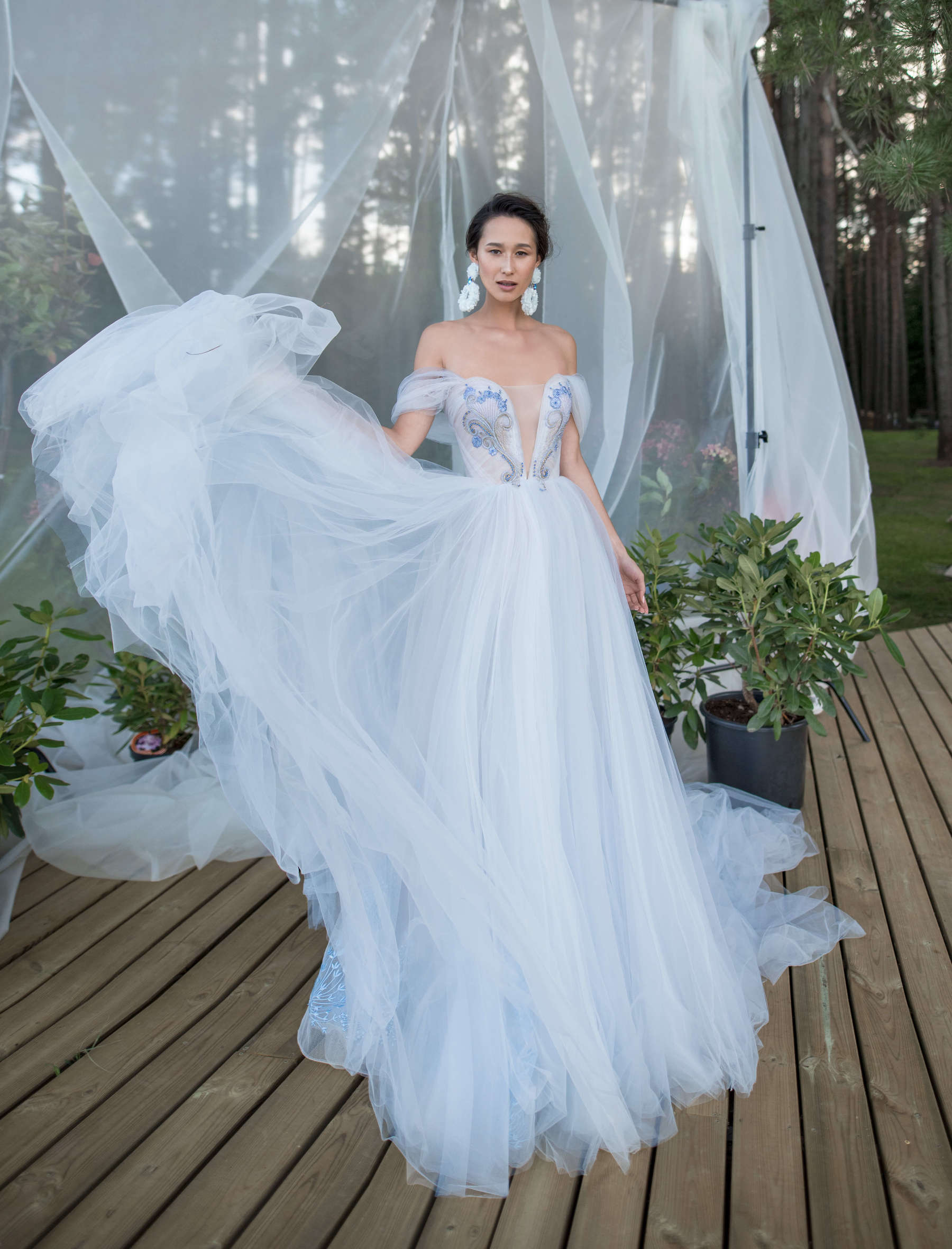 A bride wearing wedding dress with a long train, skirt decorated with lace elements and bodice decorated with beads and stones by Rara Avis at Dell'Amore Bridal, Auckland, NZ. 3
