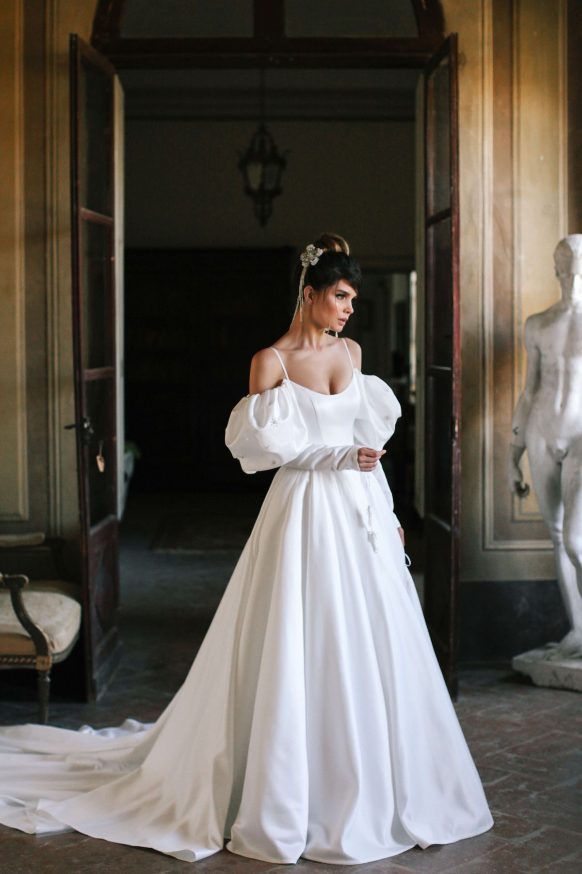 Itan wedding dress by rara avis with white satin fabric and off shoulders long sleeves at Dell'Amore Bridal, Auckland, NZ. 10