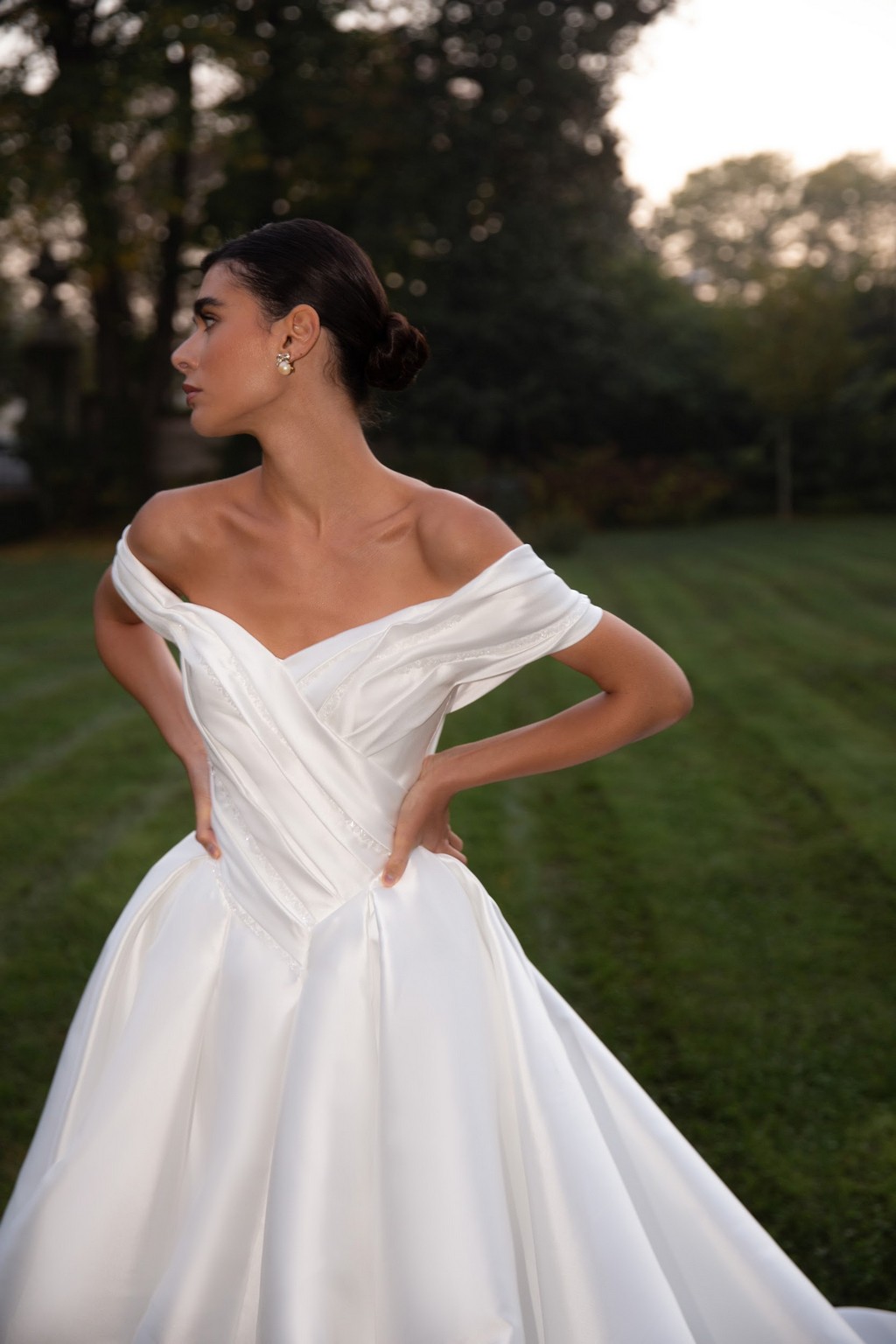 Off-shoulder satin wedding dress Shedar with wrap-over drapery corset by rara avis at Dell'Amore Bridal, NZ. 5