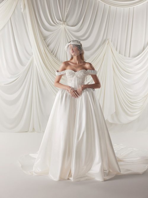 Princess off-shoulder wedding dress Sharlotta made from pearl satin by rara avis at Dell'Amore Bridal, NZ. 1
