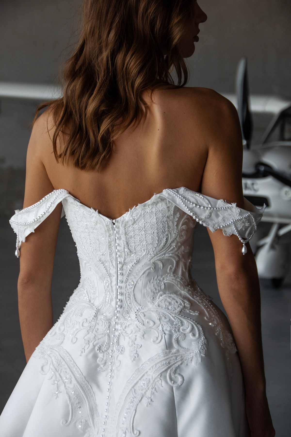 Embroidered satin wedding dress Frau with beaded and lace corset with off the shoulders sleeevs by romanova designer at Dell'Amore Bridal, NZ. 1