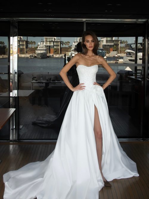 Flower draping wedding dress Harris with glittery corset and slit in the skirt by patricia couture at Dell'Amore Bridal, NZ. 2